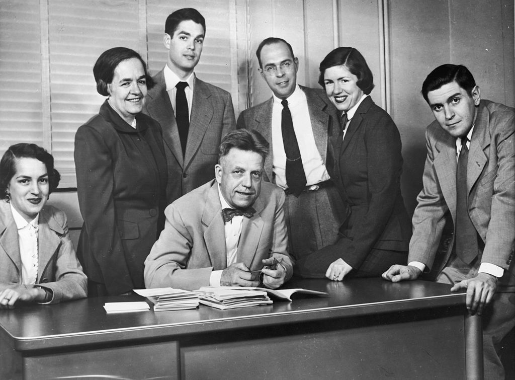 American sexuality researcher Alfred Kinsey (1894 - 1956) sits at a desk, surrounded by his family in Bloomington, Indiana, circa 1953. L-R: Daughter Joan Reid, his wife, his son Bruce, son-in-law Warren Corning, daughter Anne Corning and son-in-law Dr. Robert Reid. (Photo by Hulton Archive/Getty Images) 